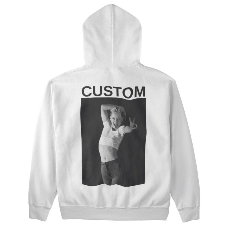 May include: White hooded sweatshirt with a black and white image on the back. The image features a person making a peace sign and sticking out their tongue. The word "CUSTOM" is printed above the image.