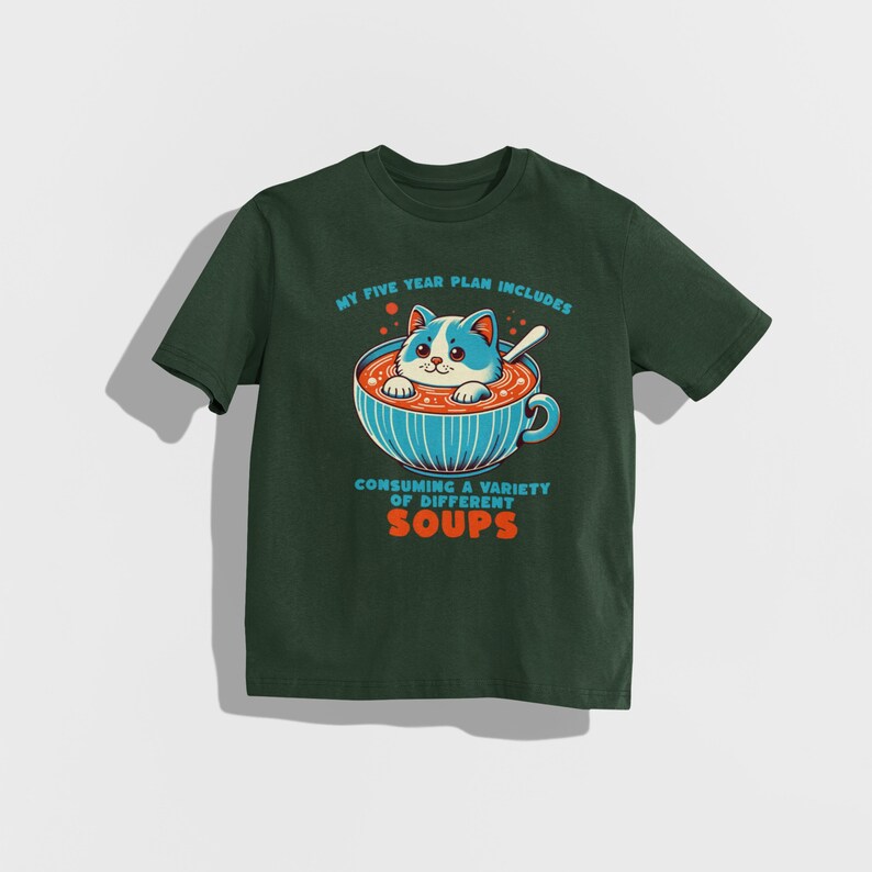 May include: A dark green t-shirt featuring a white cat in a bowl of soup. The text on the shirt reads "My five year plan includes consuming a variety of different soups."