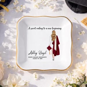 May include: White ceramic trinket dish with a gold rim, featuring a graduation illustration and the text "A sweet ending to a new beginning." The dish is personalized with a name and graduation year.