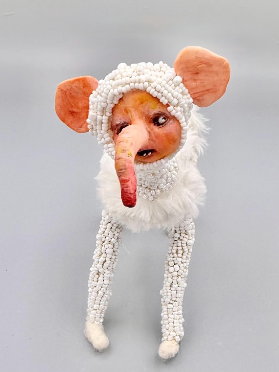 A posable, beaded 'ugly-cute' creature doll that feels like it crawled out of a fever dream — every bead placed by hand, no two alike.
