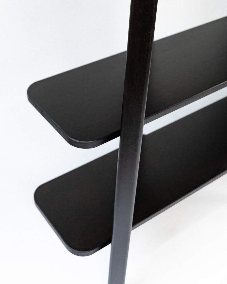 Top-down close-up of the black Wenge shelves, showing the rounded corners and smooth satin finish.