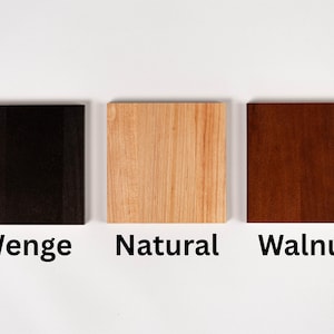 A photo of the three available wood finish swatches: Wenge (dark black-brown), Natural (light alder), and Walnut (mid-tone brown).