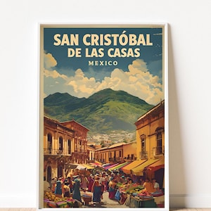 May include: A framed travel poster for San Cristóbal de las Casas, Mexico. The image shows a busy street scene with vendors, buildings, and mountains in the background. The poster has a vintage aesthetic with text at the top.