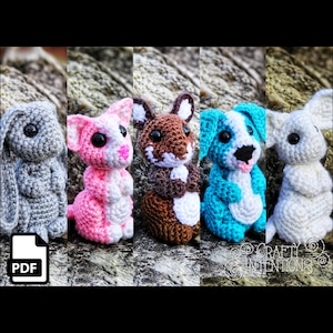 May include: Five crocheted animal figures are displayed: a grey bunny, a pink and white cat, a brown and white fox, a blue and white dog, and a white koala. Each figure has black safety eyes. A PDF icon is also present in the image.