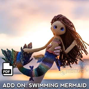 May include: A crocheted mermaid doll with a rainbow tail and brown hair. The doll has blue eyes and is held against a sunset backdrop. The text "ADD ON: SWIMMING MERMAID" is displayed at the bottom left.