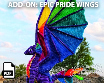 May include: A crochet dragon with rainbow wings. The dragon is purple with a rainbow tail and rainbow accents on the wings. The wings are large and spread out. The dragon is sitting on a rock. The text "ADD-ON: EPIC PRIDE WINGS" is at the top of the image. The text "PDF" is in a white box at the bottom left of the image. The text "CRAFTY INTENTIONS" is at the bottom right of the image.