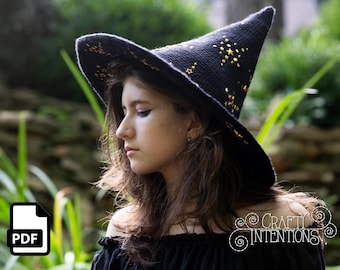 May include: A black pointed hat featuring a textured knit surface adorned with gold-colored star patterns scattered across the crown and wide brim. The hat has a tall, slightly curved peak and a wide, flexible brim that slopes downward.