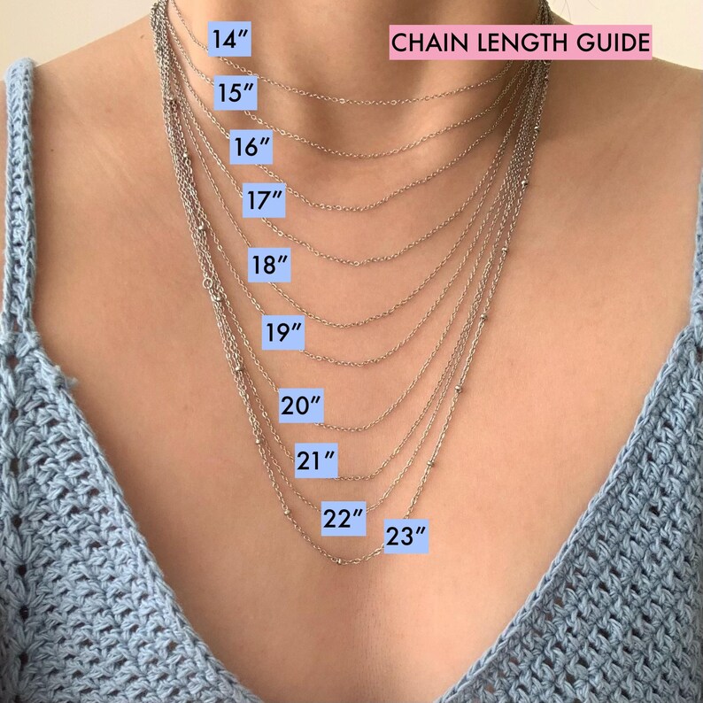 May include: A silver necklace chain length guide. The image shows multiple necklaces of varying lengths, ranging from 14 inches to 23 inches. The text "CHAIN LENGTH GUIDE" is displayed at the top. Each chain length is labeled with its corresponding measurement in inches.