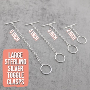 May include: Four silver toggle clasps with attached chains, labeled 2 inch, 3 inch, 4 inch, and 5 inch. A large orange box with white text reads LARGE STERLING SILVER TOGGLE CLASPS. Each clasp consists of a circular ring and a straight bar.