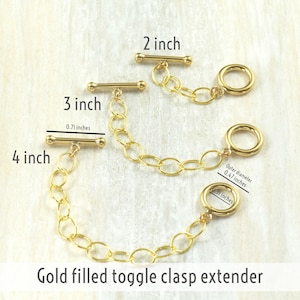 May include: Gold filled toggle clasp extender chain in three lengths: 2 inches, 3 inches, and 4 inches. The extender has a toggle clasp and a jump ring.
