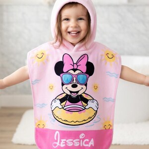 May include: A white ceramic mug with a black handle and the text "But First, Coffee" in a bold, black font. The mug is set against a blurred background, highlighting its clean design.