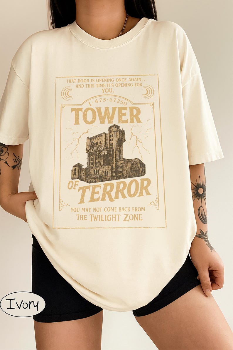 May include: Ivory t-shirt with a vintage-style graphic of the Hollywood Tower of Terror. The design includes the text "TOWER OF TERROR" and "YOU MAY NOT COME BACK FROM THE TWILIGHT ZONE."