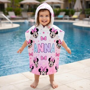 May include: A white ceramic mug with a black handle and the text "But First, Coffee" in a bold, black font. The mug is set against a blurred background, highlighting its clean design.