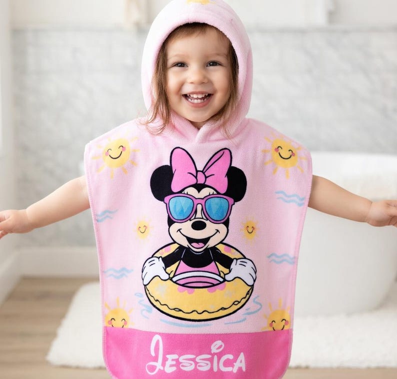 May include: A white ceramic mug with a black handle and the text "But First, Coffee" in a bold, black font. The mug is set against a blurred background, highlighting its clean design.