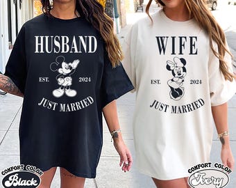 May include: Two black and white t-shirts with a Mickey Mouse and Minnie Mouse graphic. The shirts say "Husband" and "Wife" with the text "Just Married" and the year "2024".