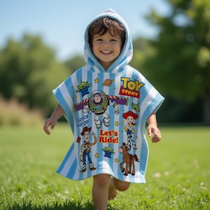 May include: A hooded beach towel featuring characters from the animated film "Toy Story." The towel is light blue with white stripes and has images of Buzz Lightyear, Woody, and other characters. The words "Toy Story" and "Let's Ride!" are also visible.