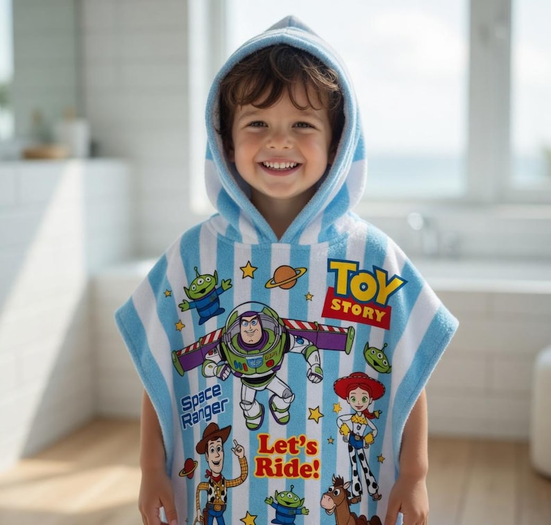 May include: A hooded, blue and white striped towel featuring Toy Story characters. The towel has images of Buzz Lightyear, Woody, and other characters. The words "Toy Story" and "Let's Ride!" are also visible on the towel.