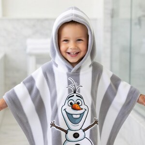 May include: A set of three ceramic mugs with a speckled, cream-colored glaze. Each mug features a different hand-painted design: a blue and green leaf, a yellow flower, and a red berry. The mugs have a simple, rounded shape.