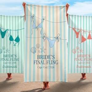May include: Three beach towels with vertical stripes in shades of blue, green, and beige. Each towel features a bikini design, seashells, and the text "BRIDE'S FINAL FLING Cape Cod 2026 Bridesmaids".