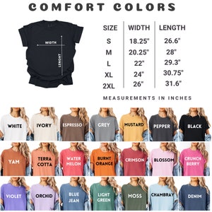 May include: A black t-shirt with size and color options. The text "COMFORT COLORS" is at the top. The size chart shows measurements in inches. Colors include white, ivory, espresso, grey, mustard, pepper, black, yam, terra cotta, water melon, burnt orange, crimson, blossom, crunch berry, violet, orchid, blue jean, light green, moss, chambray, and denim.