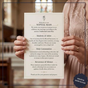 May include: A cream-colored wedding program with elegant script, held by a person. The program includes text about the nuptial mass, modesty, attire, holy communion, reverence, and silence. A digital download label is in the bottom right corner.