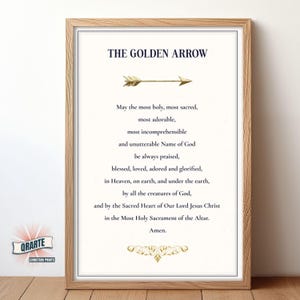 May include: Framed print featuring the text "THE GOLDEN ARROW" and a prayer. The print includes a gold arrow graphic and decorative gold accents. The frame is a light brown colour.