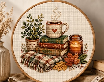Patrón de punto de cruz para un acogedor rincón de lectura otoñal: libros, taza y vela (descarga en PDF).
