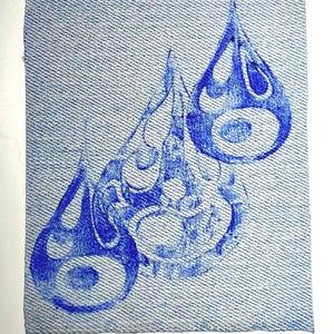 May include: Three blue teardrop-shaped designs with intricate patterns are printed on a denim-textured square. The designs have a central eye-like shape and are arranged diagonally across the fabric, creating a visually appealing composition.