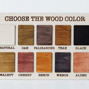 May include: A wooden color chart with the text "CHOOSE THE WOOD COLOR" at the top. The chart displays ten rectangular wood samples in various colors, including natural, oak, palisander, teak, and black.