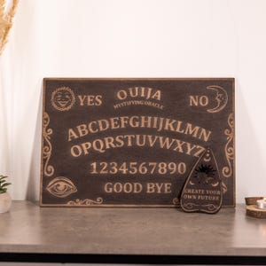 Ouijabord van hout, bordouijabord, klassiek spiritusbord, occulte oefening, geestspel, praatbord met planchette, hekserijdecor