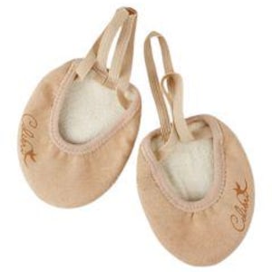 May include: Two tan ballet shoes with elastic straps and a soft interior. The shoes have a rounded toe and the word "Calida" is embroidered on the side. Designed for dance, they are set against a white background.