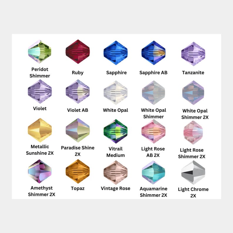 Może przedstawiać: Siatka dwudziestu fasetowanych koralik&oacute;w bicone w r&oacute;żnych kolorach i wykończeniach, każdy oznaczony nazwami takimi jak Peridot Shimmer, Ruby, Sapphire, Sapphire AB, Tanzanite, Violet, Violet AB, White Opal, White Opal Shimmer, White Opal Shimmer 2X, Metallic Sunshine 2X, Paradise Shine 2X, Vitrail Medium, Light Rose AB 2X, Light Rose Shimmer 2X, Amethyst Shimmer 2X, Topaz, Vintage Rose, Aquamarine Shimmer 2X oraz Light Chrome 2X.