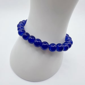 Simple blue friendship bracelet | subtly oppose Trump and Musk | size 7 inches (average / medium) | made with glass beads | profits donated
