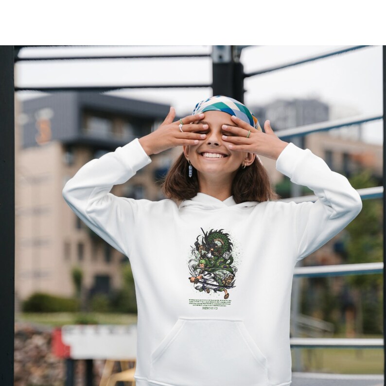 May include: White hoodie with a green and black graphic print of a dragon riding a skateboard. The text "Never Give Up" is printed below the graphic.