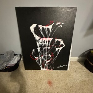 May include: Abstract painting on canvas with white and red flowers on a black background. The artist's signature is visible in the bottom right corner.