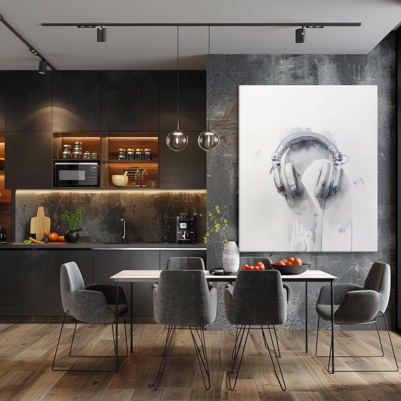 May include: A modern dining room with a dark grey kitchen and a dining table with four grey chairs. A large white canvas painting with a watercolor illustration of a pair of headphones hangs on the wall.