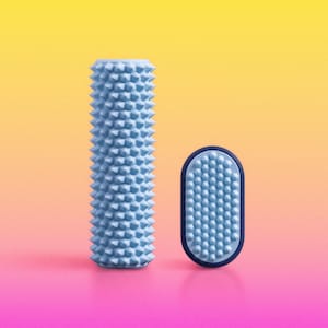 May include: A light blue cylindrical massage roller with a textured, spiked surface alongside a smaller, oval-shaped handheld massage tool featuring a matching light blue spiked surface and a dark blue outer rim for grip and handling.
