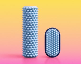 May include: A light blue cylindrical massage roller with a textured, spiked surface alongside a smaller, oval-shaped handheld massage tool featuring a matching light blue spiked surface and a dark blue outer rim for grip and handling.