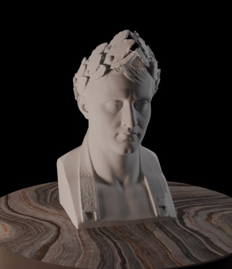 May include: A white bust of a man wearing a laurel wreath crown. The sculpture has a detailed face and shoulders, and is set against a black background. The bust is resting on a brown and tan marbled surface.