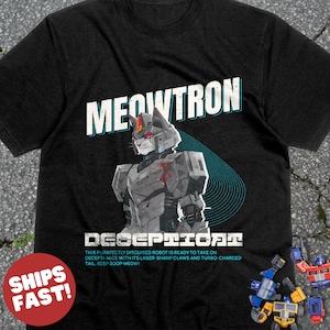 May include: Black t-shirt with a graphic of a robot cat with the text "MEOWTRON DECEPTICAT" and the text "THIS PURRFECTLY DISGUISED ROBOT IS READY TO TAKE ON DECEPTI-MICE WITH ITS LASER-SHARP CLAWS AND TURBO-CHARGED TAIL. BEEP BOOP MEOW!"
