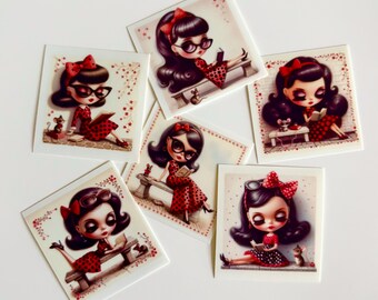 May include: A collection of five square stickers featuring illustrations of a character with dark hair, glasses, and a red polka dot dress, sitting on a bench and reading a book. Each sticker includes a small mouse and red floral accents.