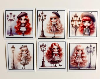 May include: Six square stickers featuring illustrations of dolls with large eyes and long hair, each standing next to a vintage-style street lamp. The dolls wear berets, striped shirts, and ruffled dresses in shades of red, pink, and white.
