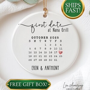 May include: A white ceramic ornament with a gold string, featuring the text "first date at Nana Grill" and a calendar for October 2025. The date October 18th is highlighted in red. The names "Erin & Anthony" are printed at the bottom.