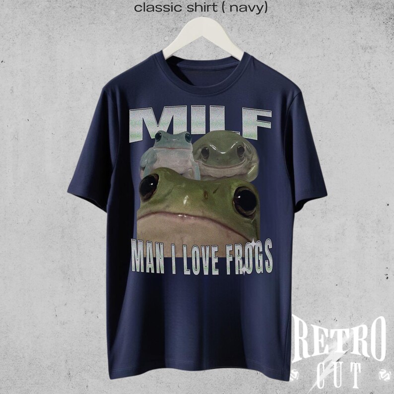 May include: A navy blue t-shirt featuring a graphic of three frogs and the text "MILF MAN I LOVE FROGS".