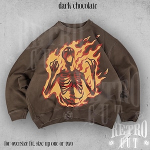 May include: Brown sweatshirt with a graphic print of a skeleton engulfed in flames. The text "dark chocolate" is at the top of the image. The text "for oversize fit, size up one or two" is at the bottom of the image.