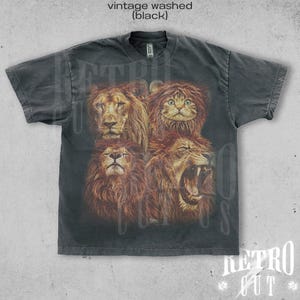 May include: A black vintage washed t-shirt with a graphic print of four lion faces, one of which is a cat wearing a lion mane.