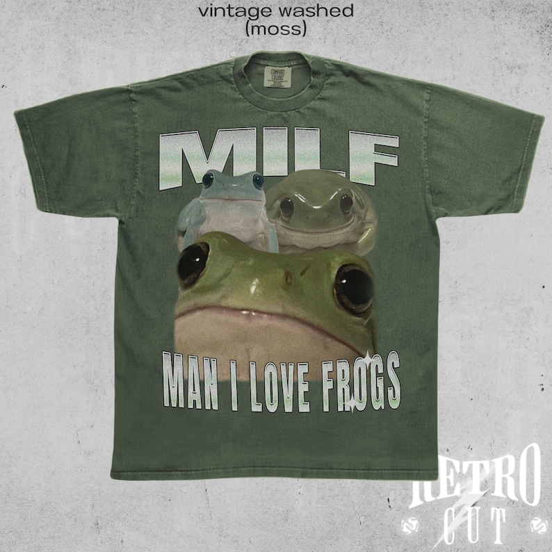 May include: Green t-shirt with a vintage washed look. The shirt features a graphic of three frogs with the text "MILF MAN I LOVE FROGS".