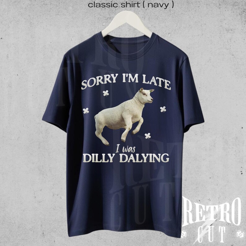 May include: A navy blue t-shirt with a white graphic of a sheep and the text "Sorry I'm Late I was Dilly Dallying".