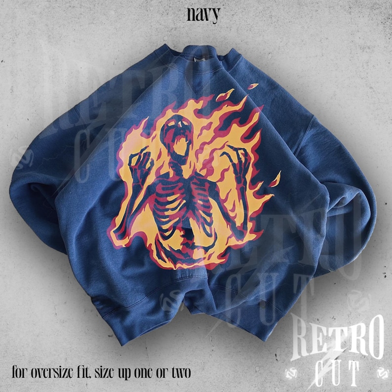 May include: Navy blue sweatshirt with a graphic of a skeleton engulfed in flames. The text "for oversize fit, size up one or two" is printed below the graphic.
