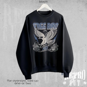 May include: Black sweatshirt with a vintage-style graphic of an eagle in flight with the text "FREE BIRD 1973".